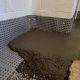 Dimple board membrane and fresh concrete along a basement perimeter